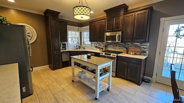137 Scott Ln, Prattville, AL 36066 - kitchen with appliances with stainless steel finishes, decorative backsplash, dark brown cabinets, hanging light fixtures, and ornamental molding