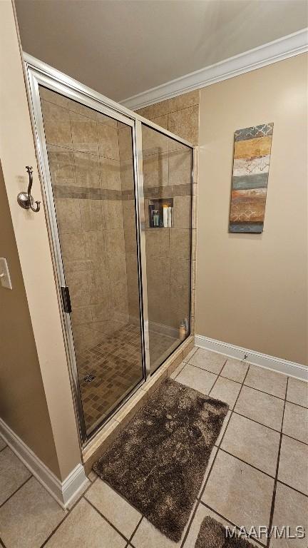 137 Scott Ln, Prattville, AL 36066 - bathroom featuring crown molding, tile patterned flooring, and a shower stall