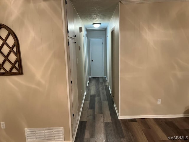 hall featuring dark hardwood / wood-style floors and a textured ceiling