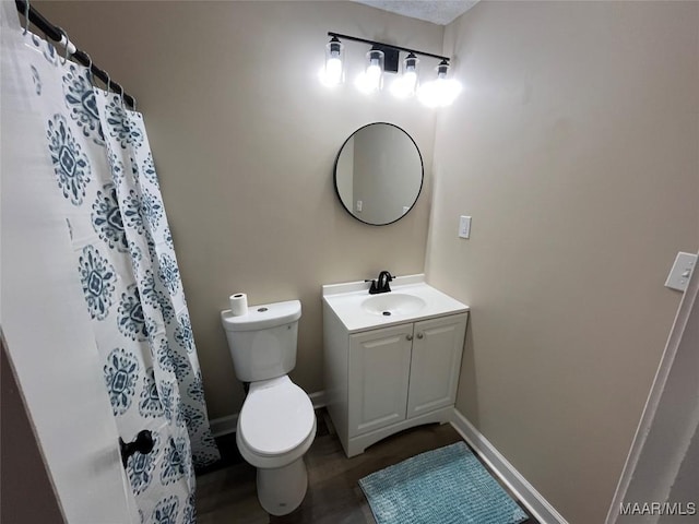 bathroom with vanity, hardwood / wood-style floors, toilet, and walk in shower