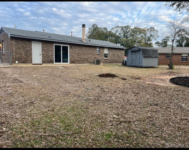 back of property featuring a shed and central air condition unit