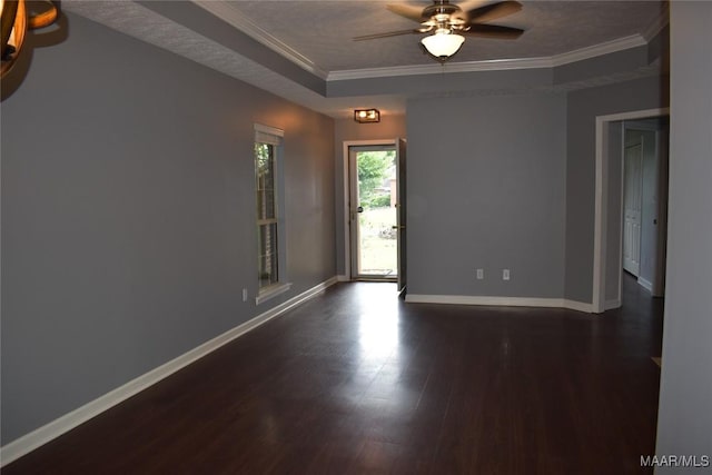 empty room with a textured ceiling, ceiling fan, dark hardwood / wood-style flooring, and crown molding