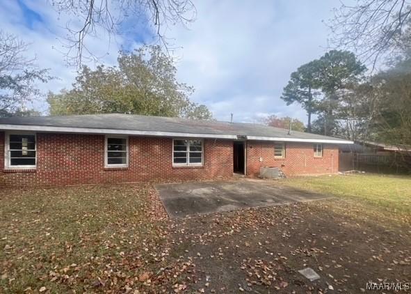 rear view of property with a patio area and a lawn