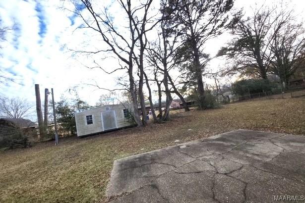 view of yard with a patio and an outdoor structure