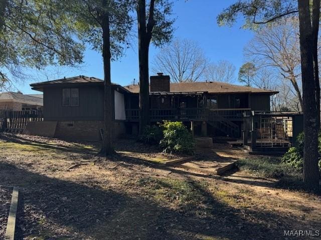 rear view of house with a wooden deck