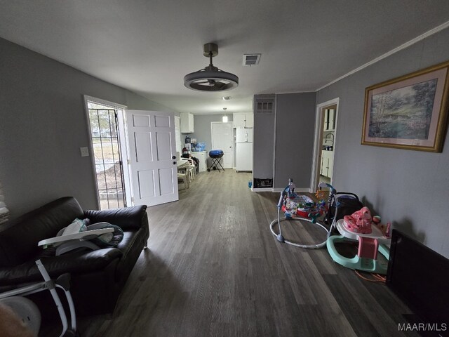 living room featuring wood-type flooring and ornamental molding