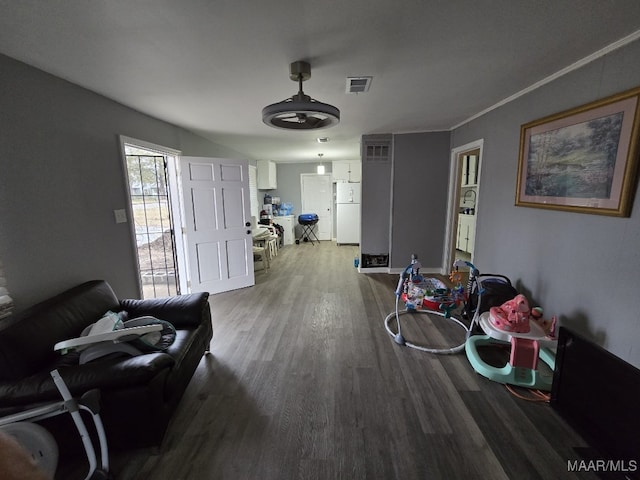 living room with hardwood / wood-style flooring and ornamental molding