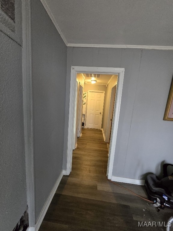 hallway featuring dark wood-type flooring and ornamental molding