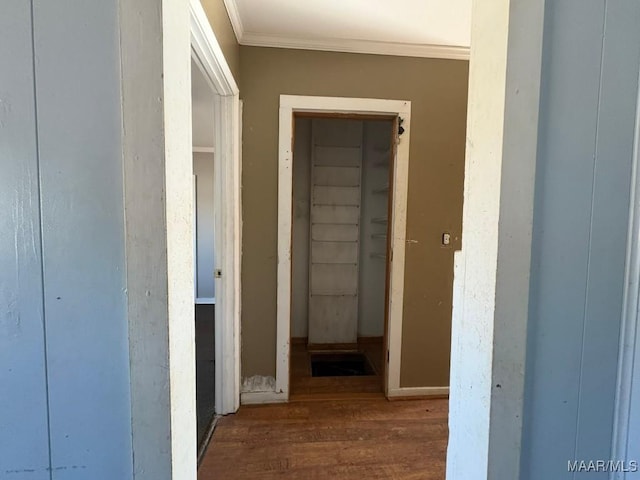 corridor with ornamental molding and dark hardwood / wood-style floors