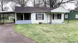 view of front of property with a front lawn and a carport