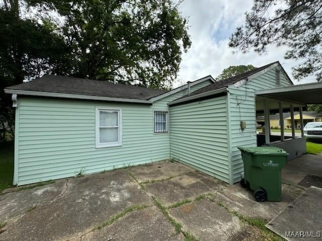 view of side of home with a patio area