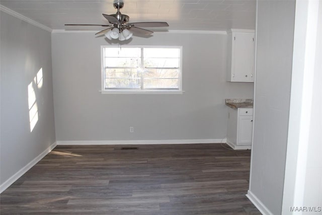 unfurnished dining area with ceiling fan, dark hardwood / wood-style flooring, and crown molding