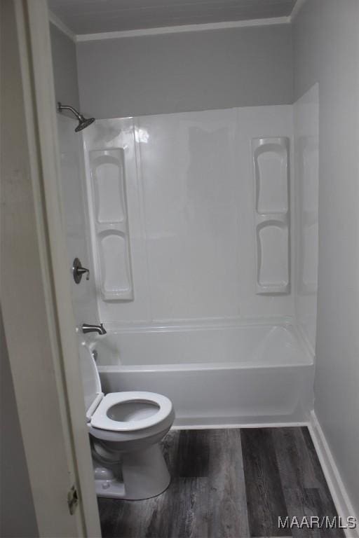 bathroom featuring toilet, bathing tub / shower combination, and hardwood / wood-style floors