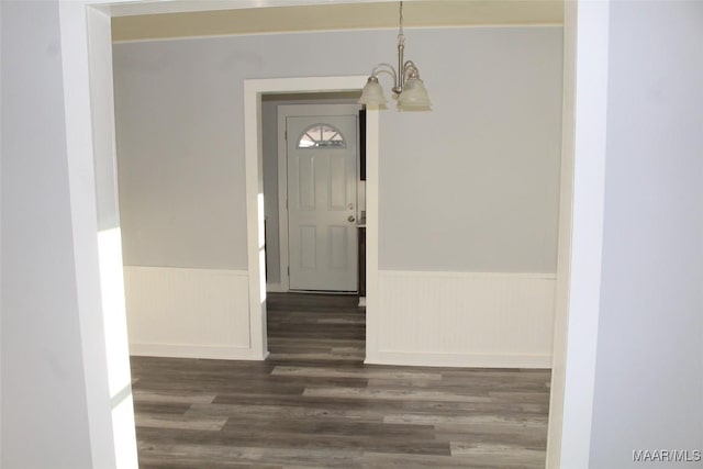 interior space with dark hardwood / wood-style flooring and an inviting chandelier