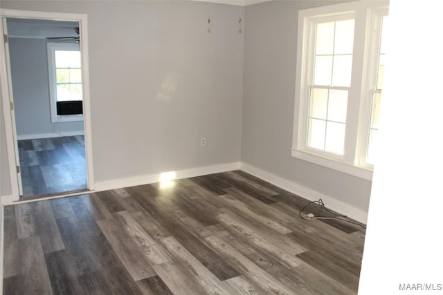 unfurnished room with ceiling fan and dark wood-type flooring