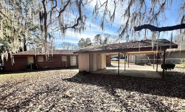 rear view of house featuring cooling unit and a carport