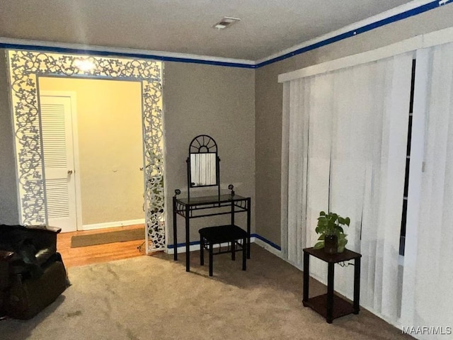 living area with carpet flooring and crown molding