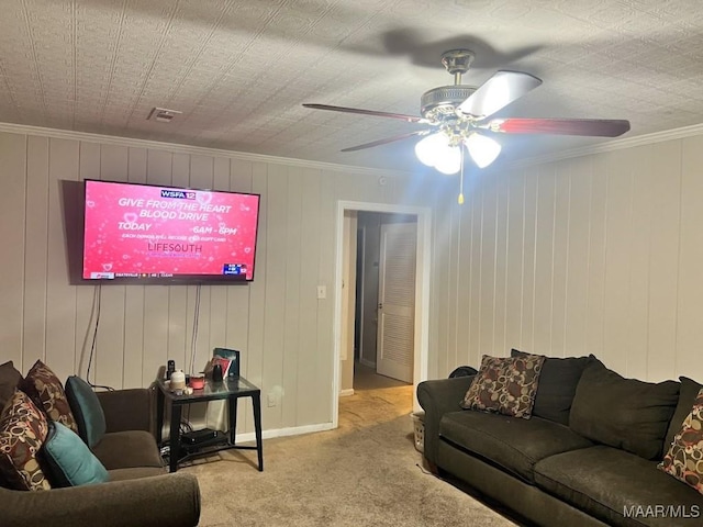 living room with ceiling fan, light colored carpet, and ornamental molding