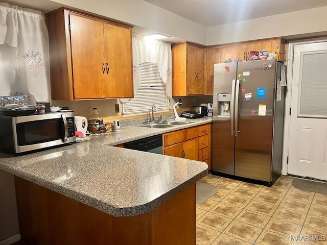 kitchen with sink, appliances with stainless steel finishes, and kitchen peninsula