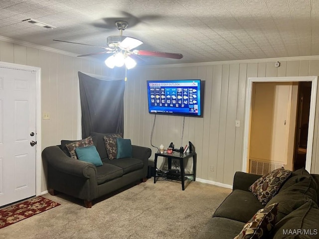 carpeted living room featuring ceiling fan and crown molding