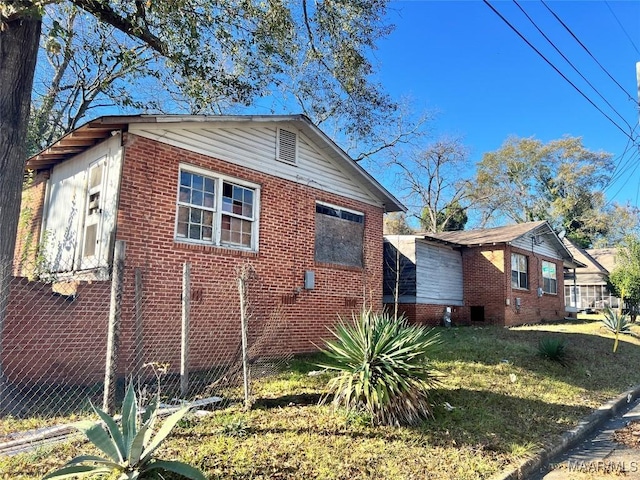 view of property exterior with a lawn