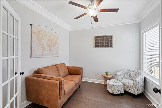 living area with a ceiling fan, dark wood-style flooring, crown molding, and baseboards