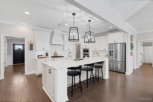 kitchen with stainless steel appliances, dark wood-style flooring, light countertops, custom exhaust hood, and a kitchen bar