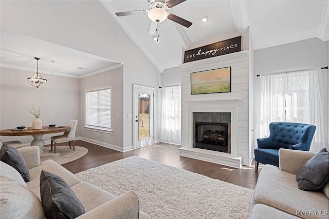 living room with ornamental molding, dark wood finished floors, and baseboards