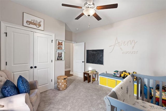 carpeted bedroom with a ceiling fan and a closet