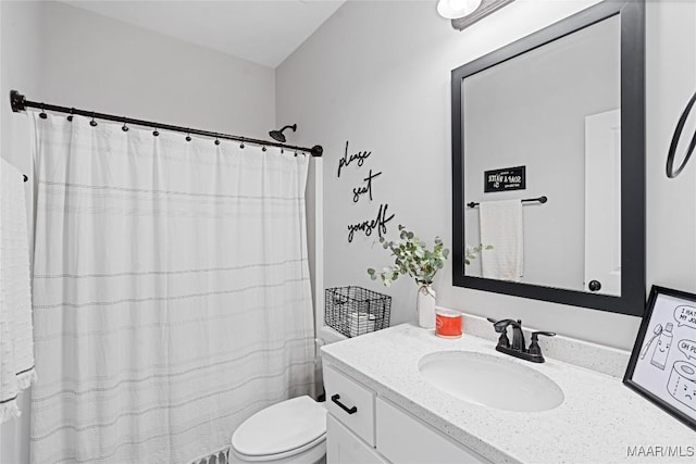 bathroom featuring toilet and vanity