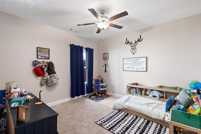 carpeted bedroom featuring ceiling fan, visible vents, and baseboards