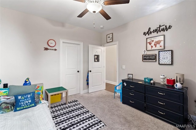 carpeted bedroom featuring baseboards and a ceiling fan