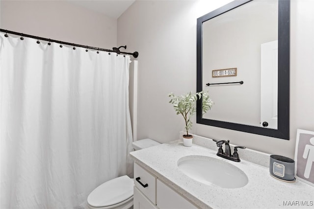 bathroom featuring toilet, a shower with curtain, and vanity