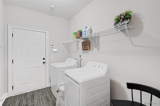 laundry area with wood finish floors, laundry area, and washing machine and clothes dryer