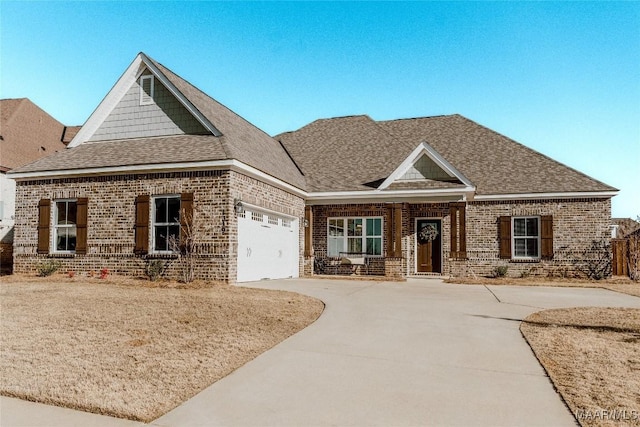 view of front of property with driveway, roof with shingles, an attached garage, and brick siding