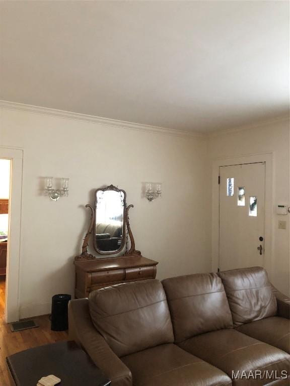 living room with ornamental molding and hardwood / wood-style floors