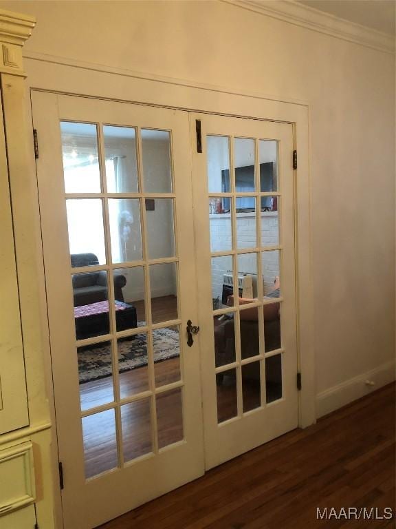 entryway with crown molding, dark wood-type flooring, and french doors