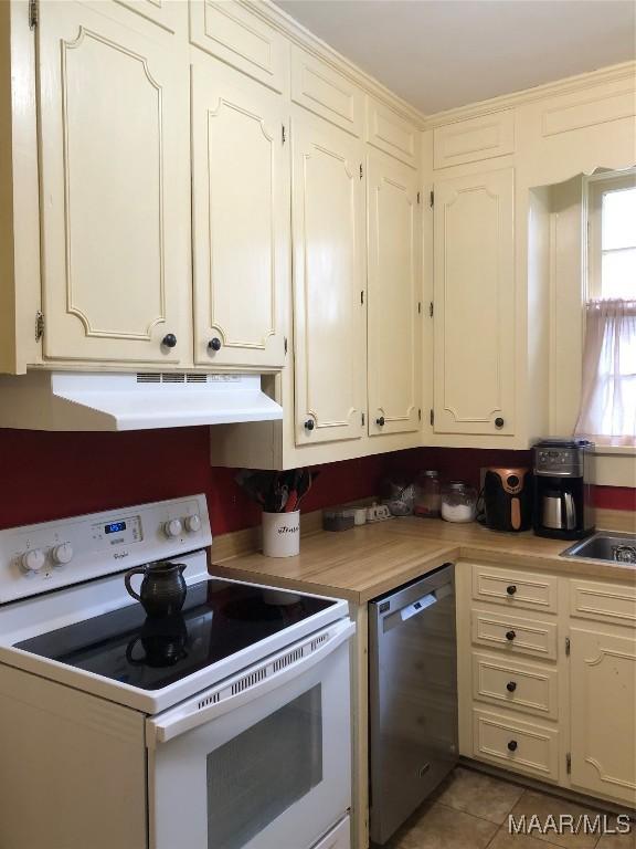 kitchen with sink, white electric stove, dishwasher, and light tile patterned flooring