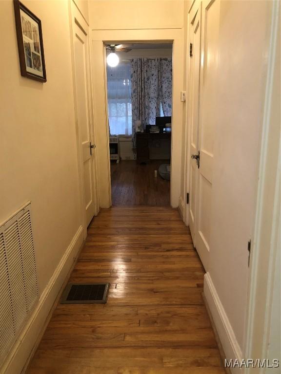 hallway featuring dark hardwood / wood-style flooring