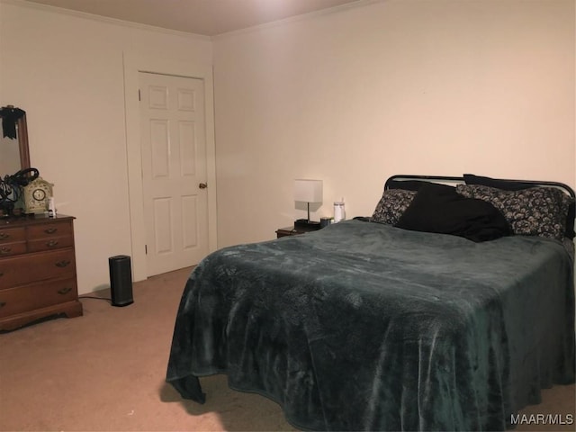 bedroom featuring ornamental molding and light carpet