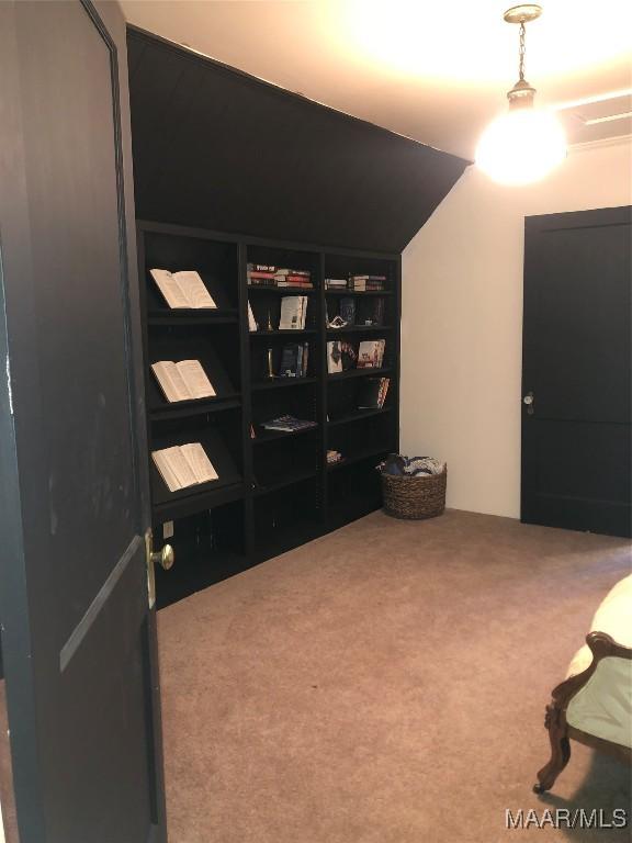 sitting room with lofted ceiling and carpet floors