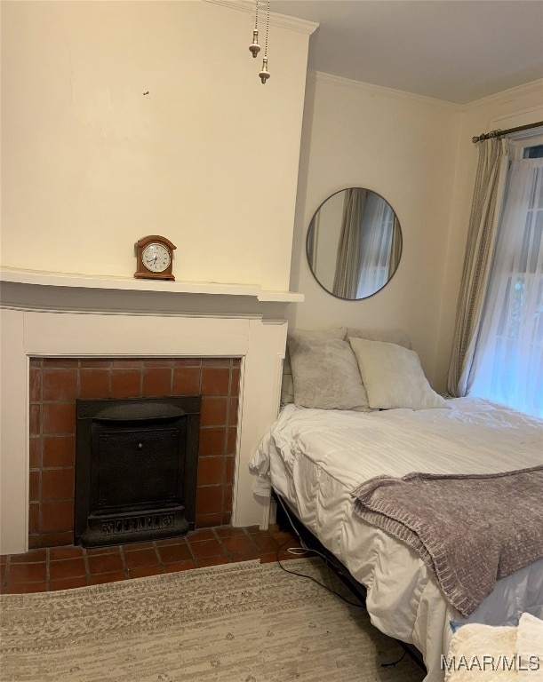 bedroom with a fireplace and ornamental molding