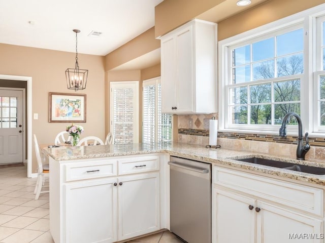 kitchen with sink, stainless steel dishwasher, white cabinetry, and tasteful backsplash