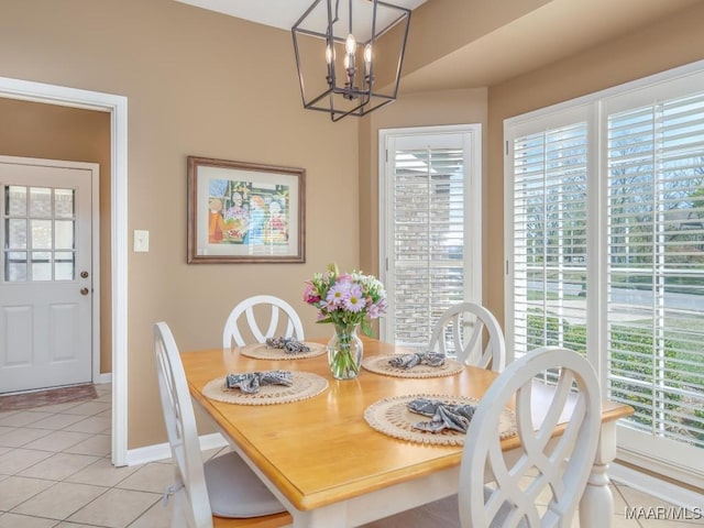 tiled dining room with a chandelier