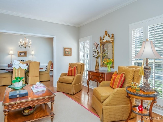 living room featuring crown molding, light hardwood / wood-style floors, and a chandelier