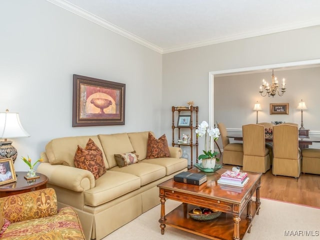 living room featuring ornamental molding, an inviting chandelier, and hardwood / wood-style floors