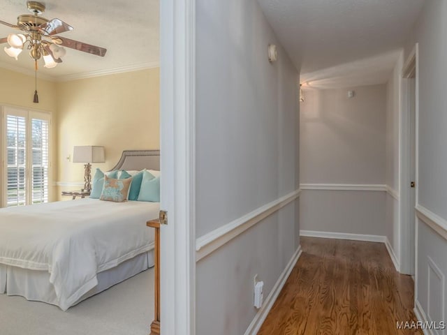 bedroom featuring wood-type flooring, ceiling fan, and ornamental molding