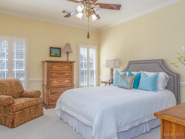 bedroom featuring ceiling fan, carpet, crown molding, and multiple windows