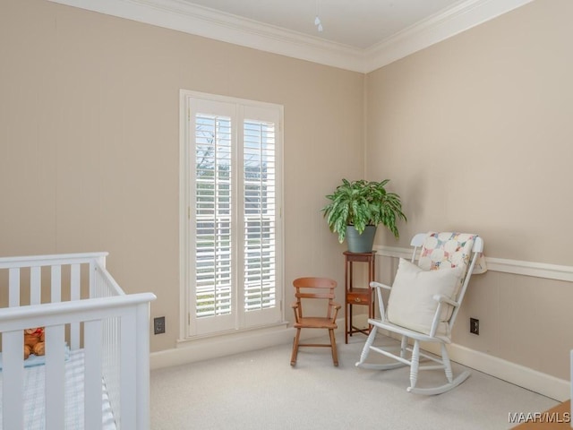 carpeted bedroom with ornamental molding and a crib