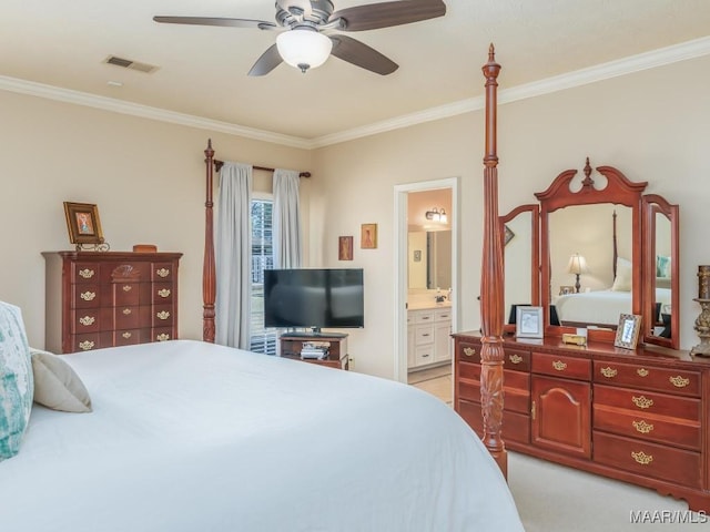 bedroom with ceiling fan, crown molding, and ensuite bath